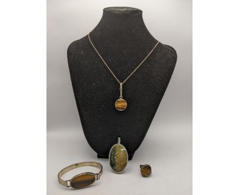 A suite of silver and white metal jewellery set with tiger eyes to include a ring, bracelet, necklace and a similar pendantLo