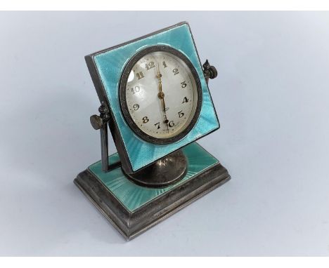 An Art Deco style green enamel on silver, swivel mounted dressing table/desk clock on a rectangular weighted base, Birmingham