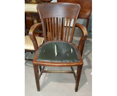 A 1930's desk arm chair with studded seat and stick back 