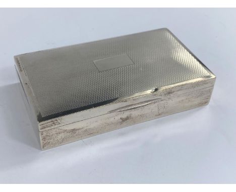 A hallmarked silver engine turned cigarette box, Birmingham date mark worn 