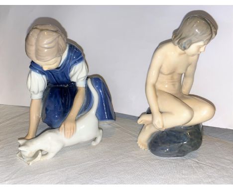 A Royal Copenhagen ceramic figure:  girl sat on rock, No 4027, height 14.5 cm; another (a.f.); a modrn Dresden figure (a.f.) 