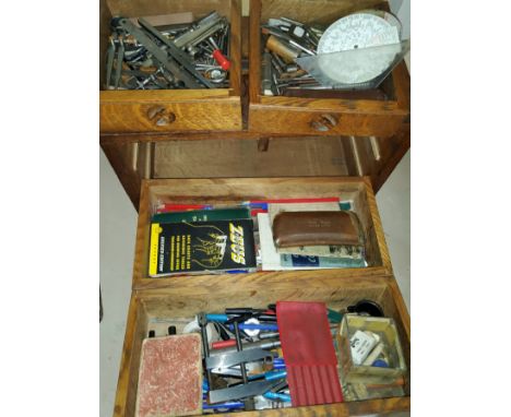 A 20th century oak tool cabinet/collector's cabinet with removable front, two short and two long drawers contaning a selectio
