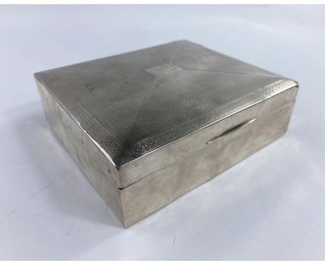 A large rectangular engine turned cigarette box, Birmingham 1928, length 17cm (various dents) 