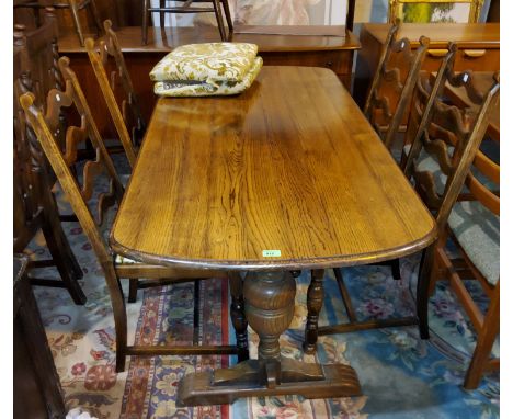 A reproduction oak dining suite with linen fold decoration comprising refectory table; 6 ladder back chairs and Welsh dresser