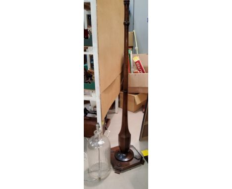 An Art Deco wood lamp standard and a glass bottle table lamp 