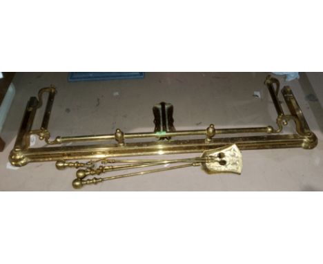 A brass fender with integral fire dogs, an oak tapestry fire screen and another similar 