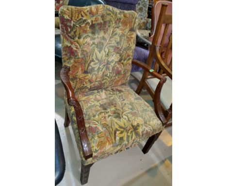 A traditional armchair in floral tapestry, and a similar rectangular stool. 