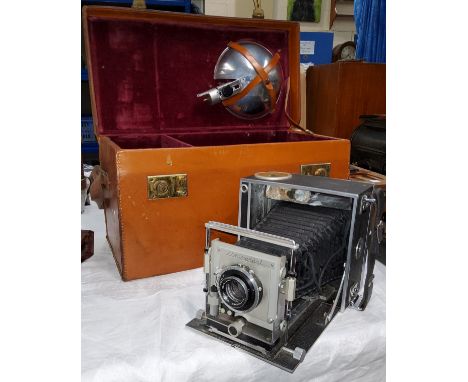 A vintage Universal Graflex style plate camera with a Syncro-Compur Ross lens, a fitted case with accessories 