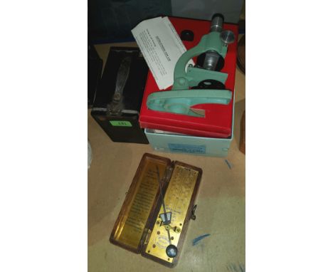 A boxed Britex Pioneer II microscope; a box camera and a wood cased metronome 
