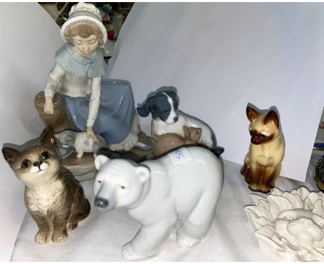 A small Beswick cat, a Lladro polar bear and a selection of Nao animals etc 