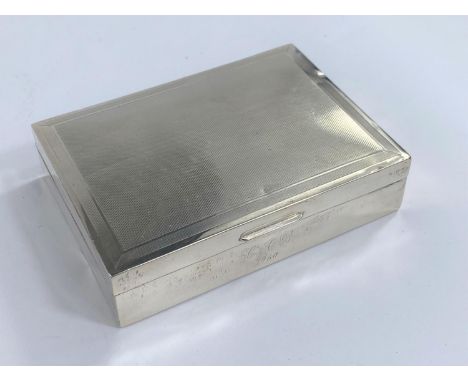 A hallmarked silver engine turned cigarette box, London, date mark worn 