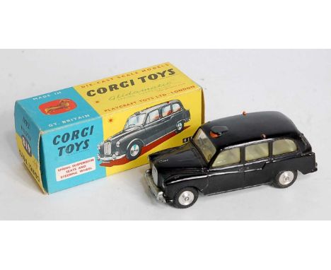 A Corgi Toys No. 418 Austin Taxi comprising of black body with lemon interior and spun hubs, housed in the original blue &amp