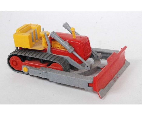 A Norev No. 111 1/43 scale plastic model of a continental CD8 bulldozer, comprising of red, yellow and grey body, with silver