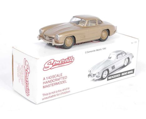 A Somerville Models No. 105 1/43 scale white metal model of a Mercedes Benz 300SL finished in gold with gold hubs and cream i