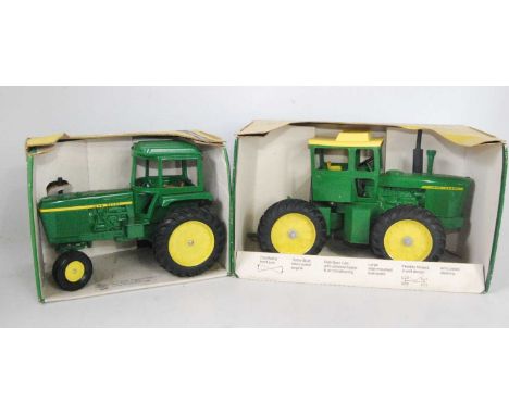 A John Deere ERTL large scale diecast group to include a John Deere Generation 2 tractor, and a 1/16 scale John Deere four wh