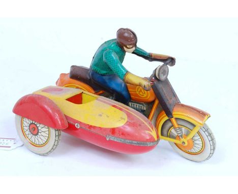 An unknown make, possibly Russian, tinplate and clockwork motorcycle and sidecar comprising of red and yellow bike and sideca