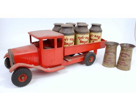 A large scale Triang pressed steel model of an open back dairy truck finished in red with matching hubs together with six Tri