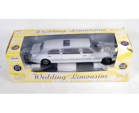 A Top Game Toys Incorporated special edition 1/18 scale model of a Lincoln Town Car stretch wedding limousine, housed in the 