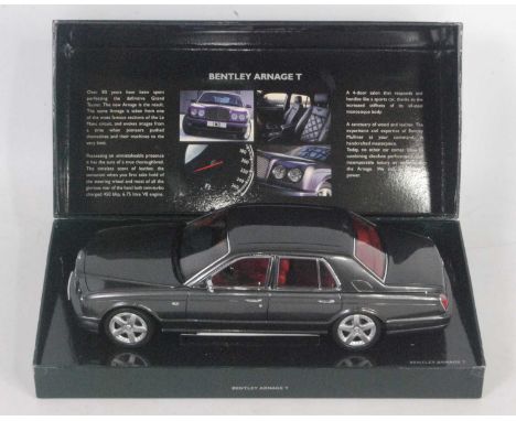 A Minichamps 1/18 scale model of a Bentley Arnage T saloon finished in dark metallic graphite grey, with red leather interior