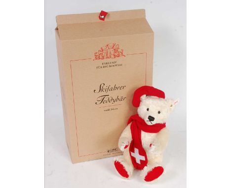 A Steiff limited edition 'The Skier' teddy bear, white mohair example ,dressed in hat, Swiss scarf with skiis and poles, limi