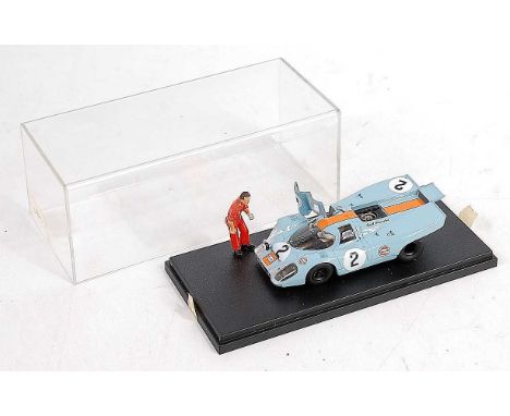 A PL Models 1/43 scale factory built kit of a Porsche 917K 1971 Sebring race car, with mechanic standing figure applying tape