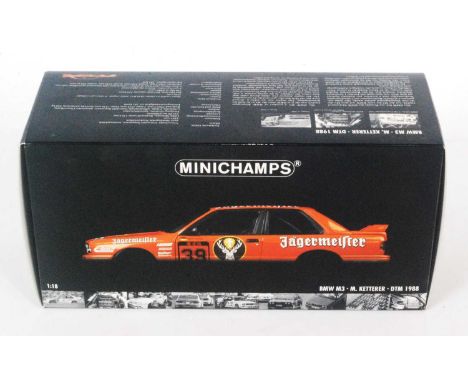 A Minichamps Model No. 882039 1/18 scale model of a BMW M3 DTM 1988 race car finished in orange with J livery and racing No. 