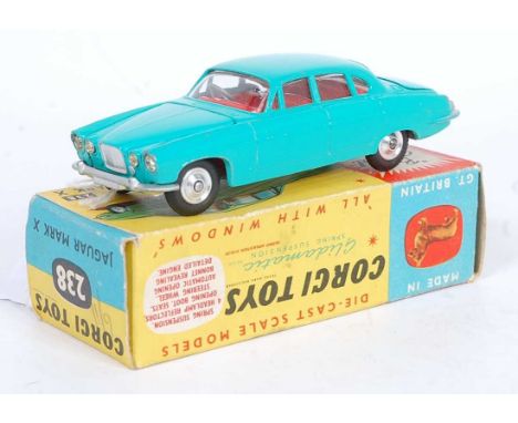 A Corgi Toys No. 238 Jaguar Mk10 comprising of pale green body with red interior and spun hubs complete with suitcase load, m