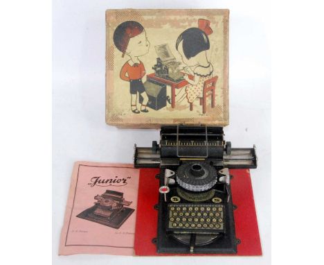 A Vintage Schmidt Brothers Junior tinplate typewriter circa 1920s comprising of black body with nicely detailed tinprinted le
