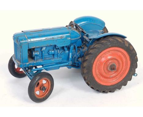 A Chad Valley diecast and clockwork model of Fordson Major tractor comprising of blue body with orange hubs and clockwork mec