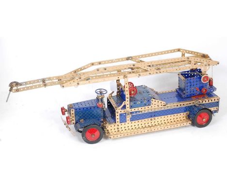 A Meccano home-made model of a vintage turntable fire engine, fitted with extending ladder constructed from mainly gold, red 