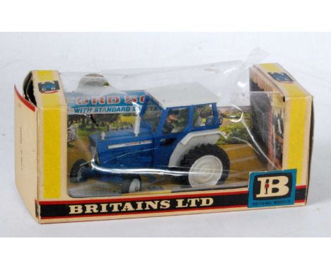 A Britains No. 9527 Ford 5000 tractor with safety cab, housed in the original window box, box in heavily worn condition and m