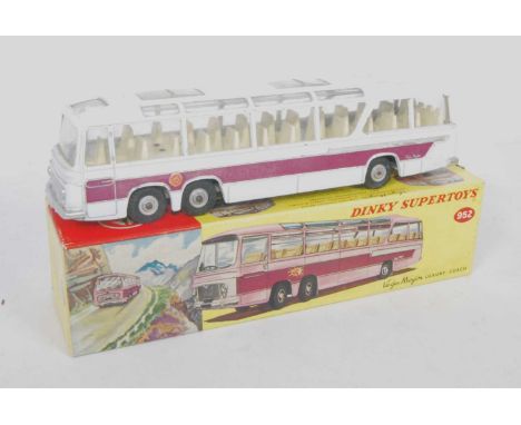 A Dinky Toys No. 952 Vega Major Luxury Coach comprising of off-white body with light yellow interior, purple and silver side 