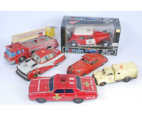 A collection of various boxed and loose tinplate, clockwork and battery operated emergency services vehicles and saloons to i