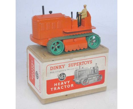 A Dinky Toys No. 563 heavy tractor, comprising orange body with tan driver and green tracks, housed in the original buff colo