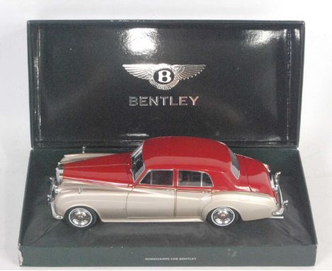 A Minichamps No. 139950 1/18 scale model of a Bentley S2 1954 saloon finished in red and silver as issued in the original Min