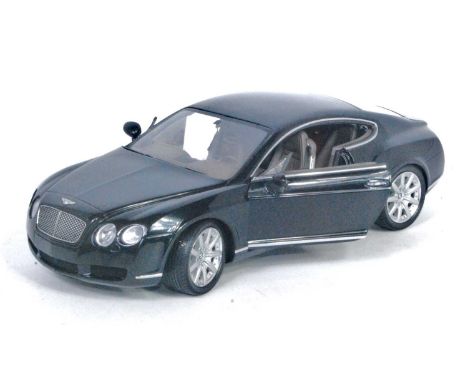 A Minichamps 1/18 scale model of a Bentley Continental GT finished in black with brown interior, loose example with minor rep