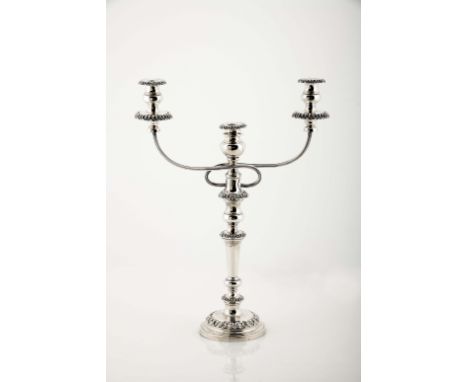 A large candlestick with a three-light serpentine, 826/1000 silver, friezes with decoration en relief, base engraved with mon