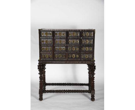A twelve drawer cabinet simulating sixteen with stand, Brazilian rosewood and Brazilian rosewood veneer, wavy front and side 