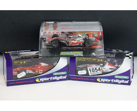 Three cased / boxed Scalextric Digital F1 slot cars to include C2676D Ferrari F2004 No1, C2715D Honda F1 No 12 and C2806D Vod