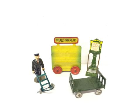 Johillco and other railway related figures: lead porter with sack truck, scales and trolley. Overall VG. Together with a tinp