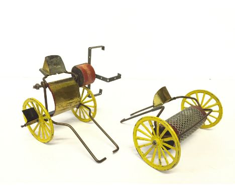 Two tinplate farm implements, both horse drawn (lack horses) with yellow spoked wheels, the first with wooden block attached 