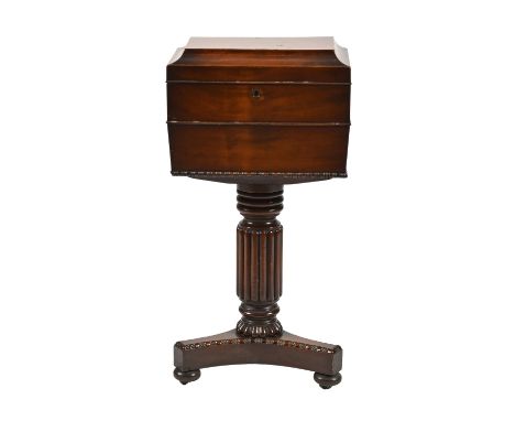 A Victorian mahogany teapoy, of sarcophagus shape, on reeded pillar and bun feet, 71cm h; 23 x 36cm Restored; gutted, veneers