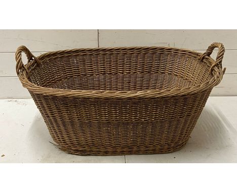 A vintage two handled wicker basket 