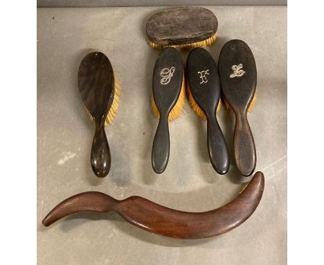 A selection of vintage hair brushes and a top hat brush