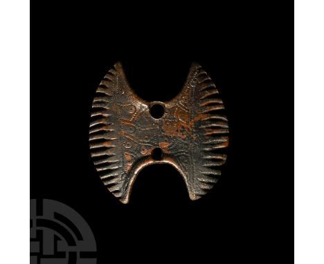 10th-11th century A.D. Composed of two crescentic arms, bifacial pecked and punched ring-and-dot motifs to the body; two perf