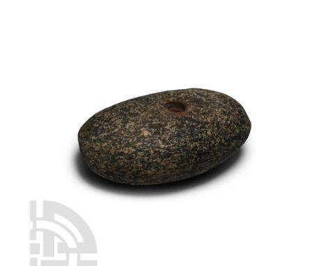 Neolithic Period, 4th-3rd millennium B.C. Of lentoid cross-section, with central cylindrical socket. 1.07 kg, 14 cm (5 1/2 in