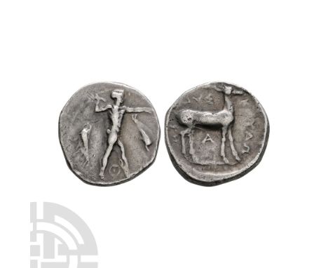 420-410 B.C. Obv: Apollo walking right, holding branch, dolphin upwards to left and dolphin downwards to right; ? between leg