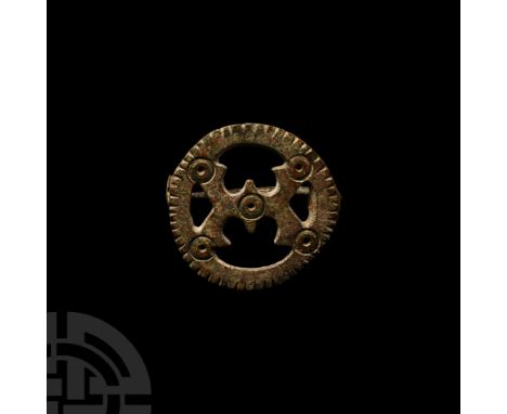 2nd century A.D. With openwork design enclosed in a notched roundel, addorsed c-shaped central spokes and punched ring-and-do
