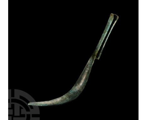 Circa 1st century A.D. Comprising a shallow U-section curved head and rectangular handle folded at the top to create a suspen