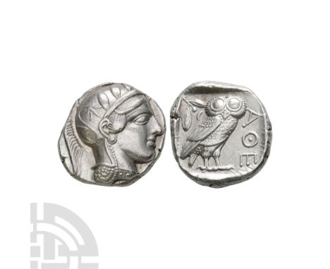 Circa 420 B.C. Obv: helmeted head of Athena right, full eye, wearing earring, necklace, and crested Attic helmet ornamented w